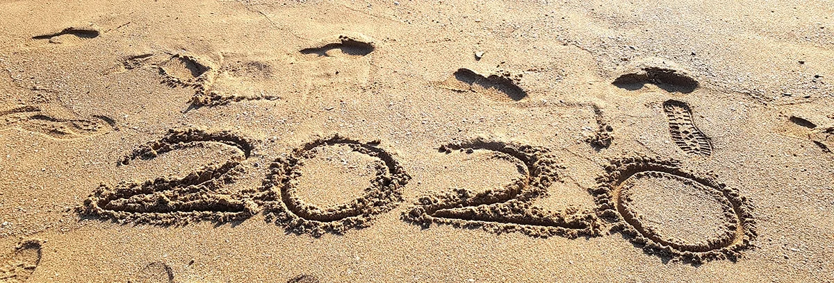 2020 scratched into a beach